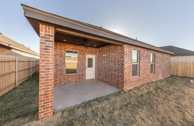 back of property with a patio area, ceiling fan, and a lawn