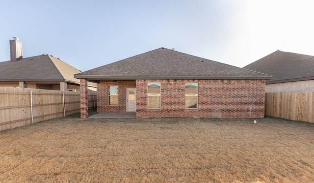 back of property featuring a lawn and a patio area