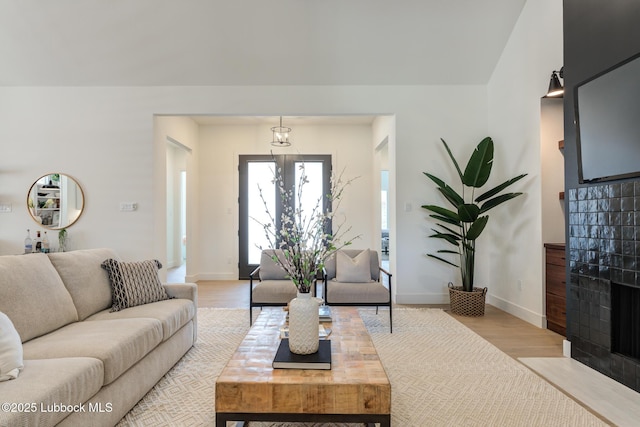4029 136th St, Lubbock, TX 79423 - living area with light wood-style floors, a fireplace with flush hearth, and baseboards