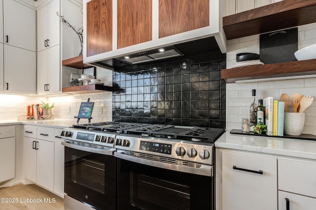 4029 136th St, Lubbock, TX 79423 - kitchen featuring stainless steel gas range, open shelves, backsplash, white cabinetry, and light wood-style flooring