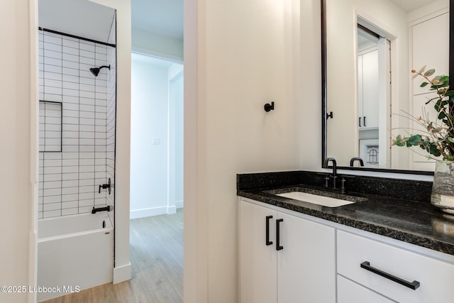 4029 136th St, Lubbock, TX 79423 - full bathroom with vanity, wood finished floors, shower / washtub combination, and baseboards
