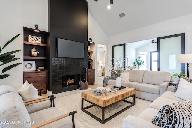 4029 136th St, Lubbock, TX 79423 - living room with a ceiling fan, high vaulted ceiling, and a tile fireplace