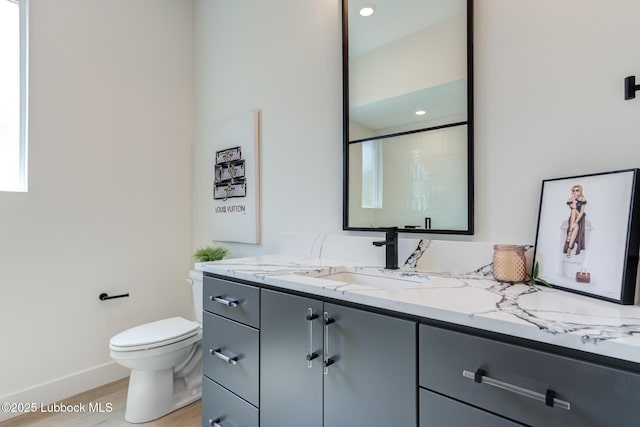 4029 136th St, Lubbock, TX 79423 - full bathroom featuring vanity, toilet, wood finished floors, baseboards, and a shower
