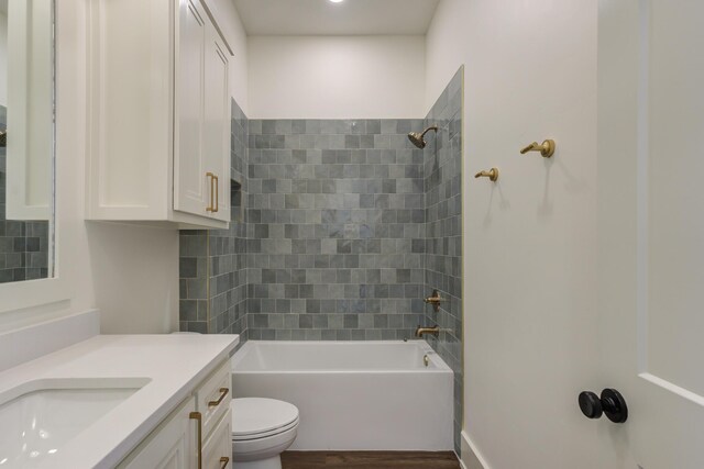 7710 46th St, Lubbock, TX 79407 - bathroom with vanity, washtub / shower combination, and wood finished floors