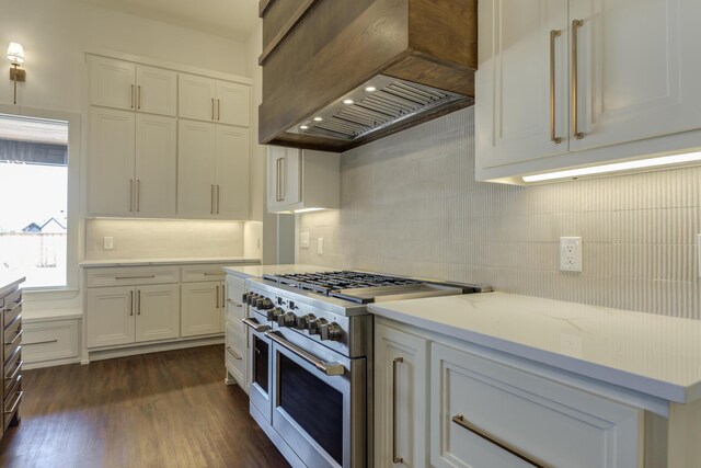 7710 46th St, Lubbock, TX 79407 - kitchen with range with two ovens, custom range hood, tasteful backsplash, and white cabinets
