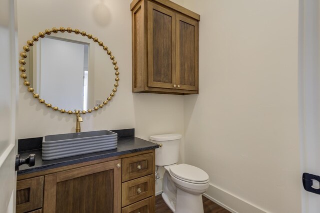 7710 46th St, Lubbock, TX 79407 - half bathroom with vanity and wood finished floors
