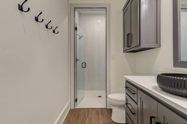 7710 46th St, Lubbock, TX 79407 - bathroom with a shower stall, vanity, and wood finished floors