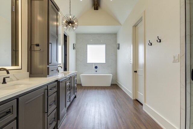 7710 46th St, Lubbock, TX 79407 - full bathroom with wood finished floors, a freestanding bath, and double vanity