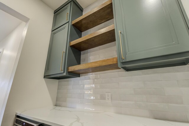 7710 46th St, Lubbock, TX 79407 - kitchen view of open shelves, backsplash, and light stone counters