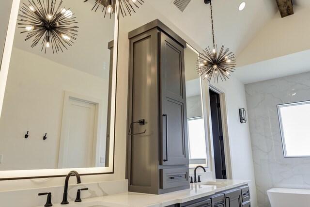 7710 46th St, Lubbock, TX 79407 - bathroom with a chandelier, double vanity, a freestanding tub, and lofted ceiling