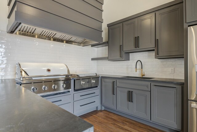 7710 46th St, Lubbock, TX 79407 - kitchen with custom exhaust hood, freestanding refrigerator, tasteful backsplash, dark countertops, and dark wood-style floors