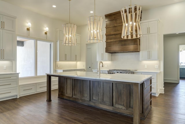 7710 46th St, Lubbock, TX 79407 - kitchen with a chandelier, white cabinets, dark wood-type flooring, a center island with sink, and tasteful backsplash