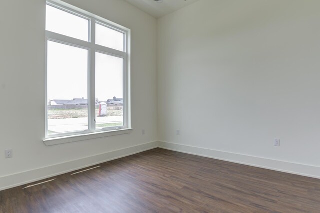 7710 46th St, Lubbock, TX 79407 - empty room featuring dark wood-type flooring and baseboards