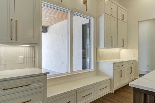 7710 46th St, Lubbock, TX 79407 - kitchen with tasteful backsplash, light stone countertops, dark wood finished floors, and white cabinets