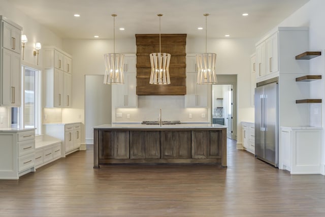 7710 46th St, Lubbock, TX 79407 - kitchen with high end refrigerator, dark wood-type flooring, open shelves, tasteful backsplash, and light countertops