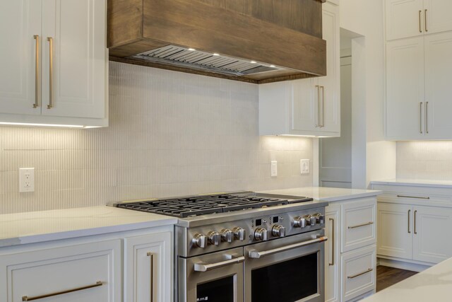 7710 46th St, Lubbock, TX 79407 - kitchen with range with two ovens, custom range hood, backsplash, and white cabinets
