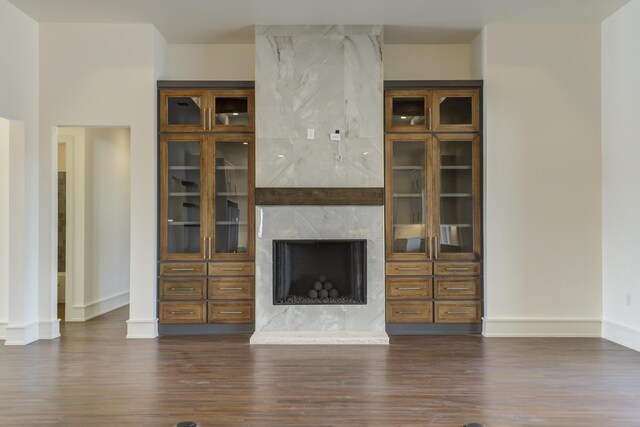 7710 46th St, Lubbock, TX 79407 - unfurnished living room with dark wood finished floors and a premium fireplace