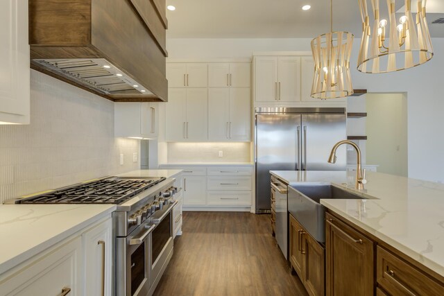7710 46th St, Lubbock, TX 79407 - kitchen with custom range hood, appliances with stainless steel finishes, decorative backsplash, dark wood-type flooring, and white cabinets