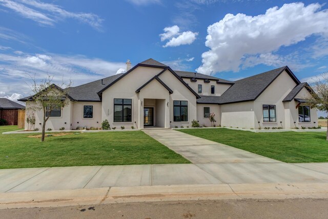 7710 46th St, Lubbock, TX 79407 - french country inspired facade with stucco siding, a front lawn, a chimney, and roof with shingles