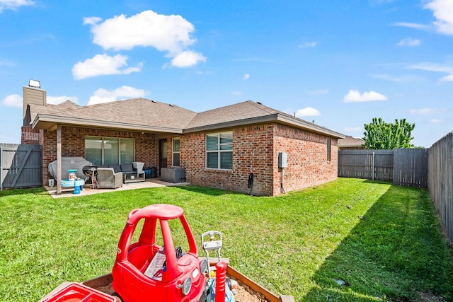 back of property featuring brick siding, an outdoor living space, a patio, and a chimney