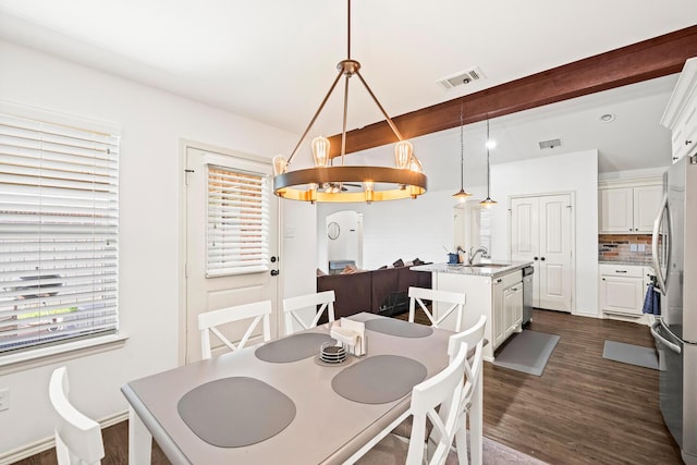 dining space with healthy amount of natural light and dark wood-style flooring