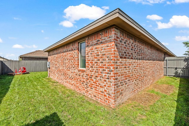 view of side of property featuring brick siding