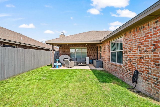 rear view of house featuring outdoor lounge area, brick siding, a patio, a shingled roof, and a chimney
