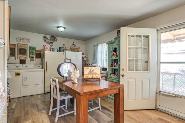 dining space with hardwood / wood-style floors and washing machine and clothes dryer