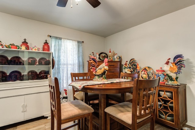 dining room with ceiling fan and light wood-type flooring