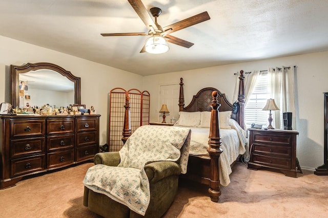 bedroom featuring ceiling fan and light carpet