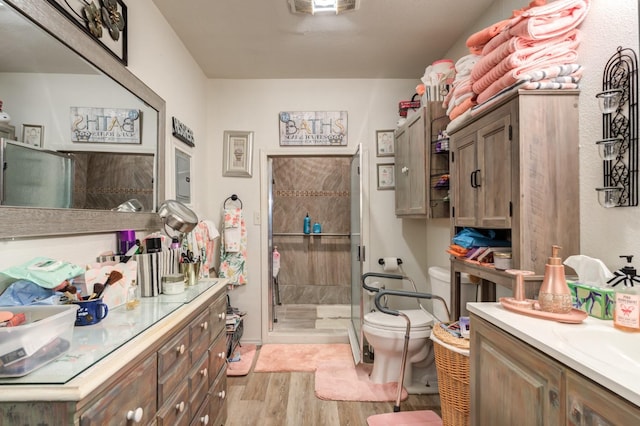 bathroom featuring hardwood / wood-style flooring, vanity, and toilet