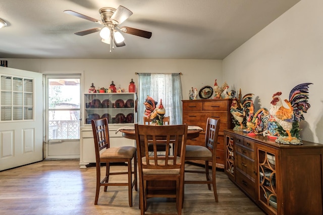 dining area with hardwood / wood-style flooring and ceiling fan