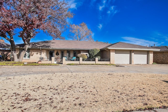 ranch-style home with brick siding, driveway, and an attached garage