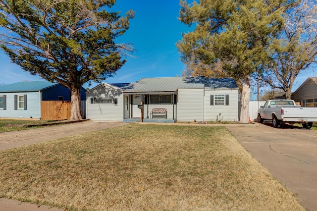 ranch-style house featuring a porch and a front yard