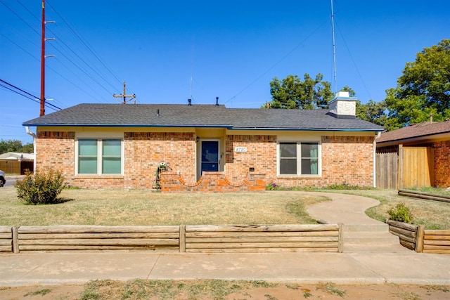 rear view of house with a lawn