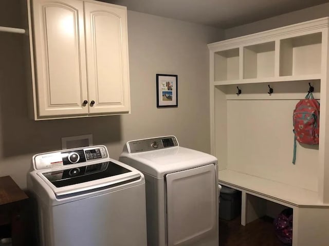 laundry room featuring washing machine and dryer and cabinets