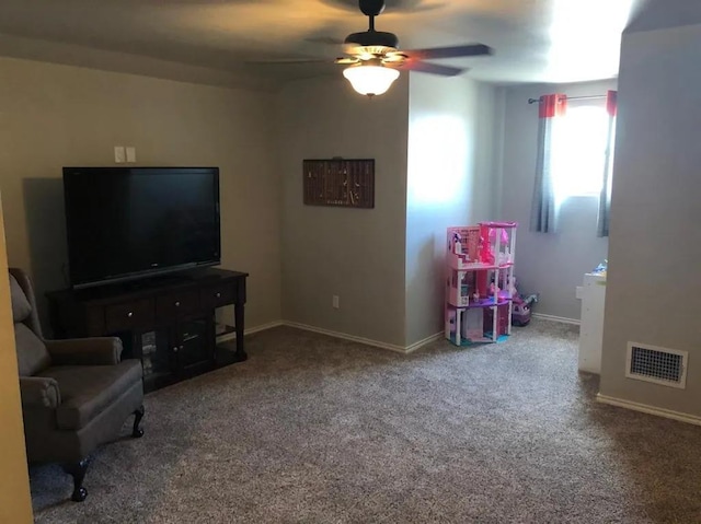 interior space featuring ceiling fan and carpet