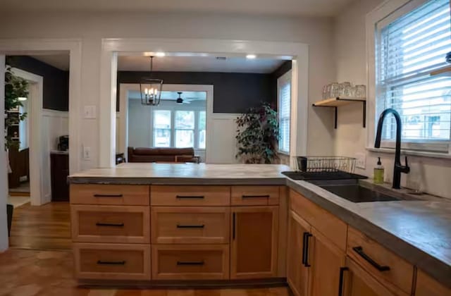 kitchen with sink, decorative light fixtures, and ceiling fan