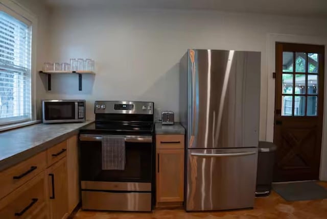 kitchen featuring appliances with stainless steel finishes and plenty of natural light