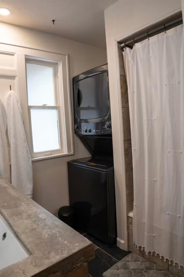 bathroom featuring vanity and stacked washer / drying machine