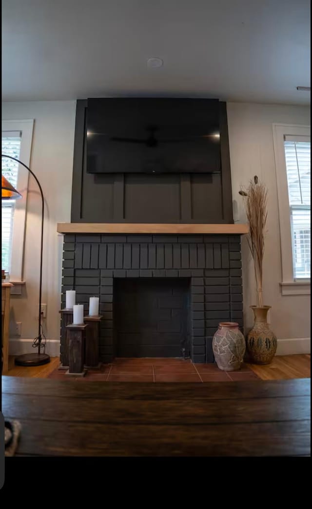 interior details with hardwood / wood-style flooring and a fireplace