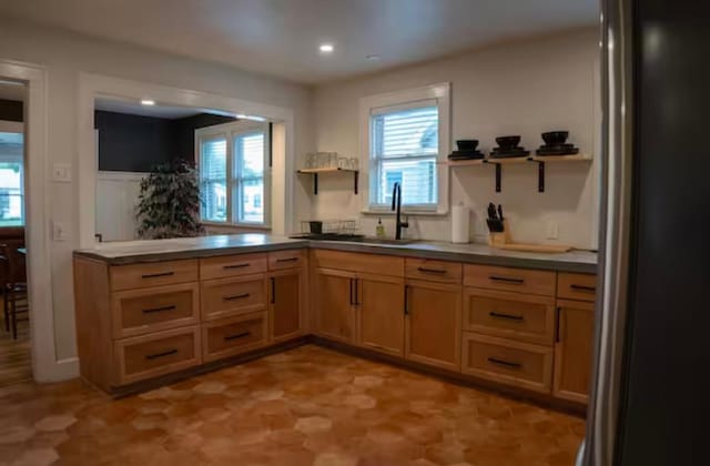 kitchen featuring stainless steel refrigerator and sink