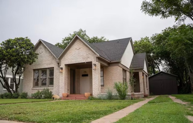 view of front of house with a front yard and a storage unit