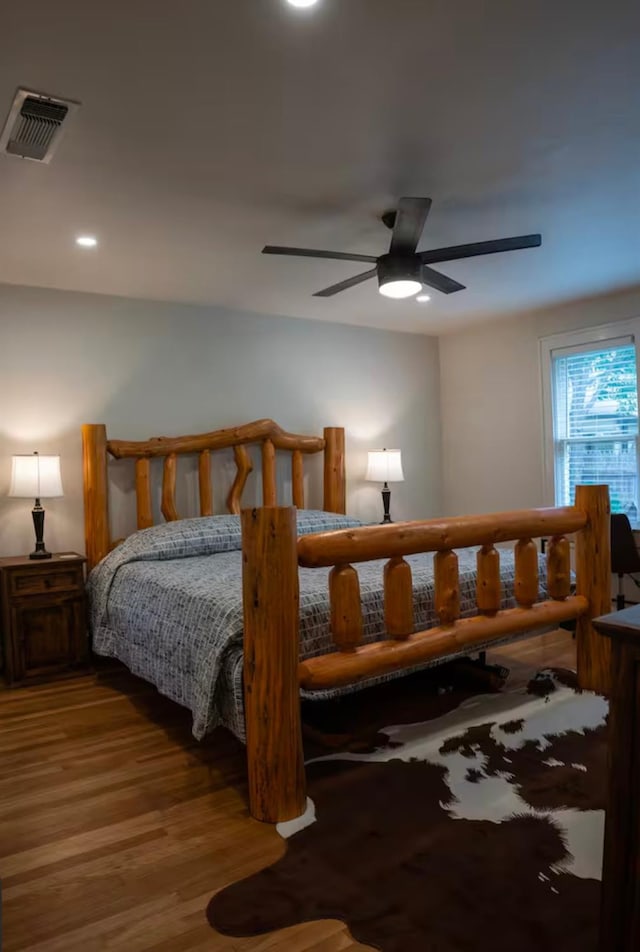 bedroom with hardwood / wood-style flooring and ceiling fan