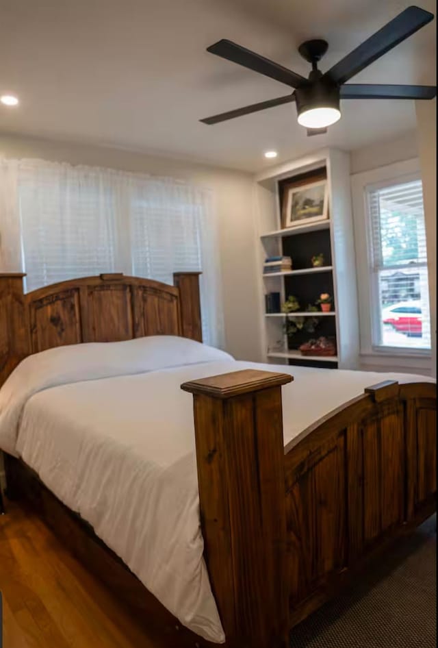 bedroom with ceiling fan and dark hardwood / wood-style floors