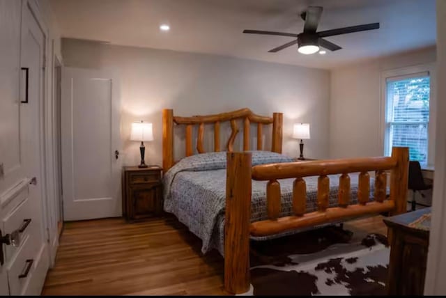 bedroom with light hardwood / wood-style floors and ceiling fan