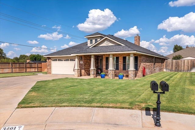 view of front of home with a garage and a front lawn