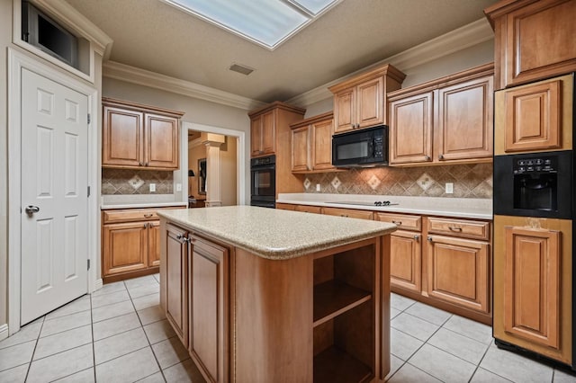 kitchen with light tile patterned floors, a center island, tasteful backsplash, ornamental molding, and black appliances