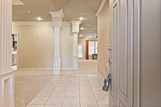 corridor featuring light carpet, ornamental molding, a textured ceiling, and ornate columns