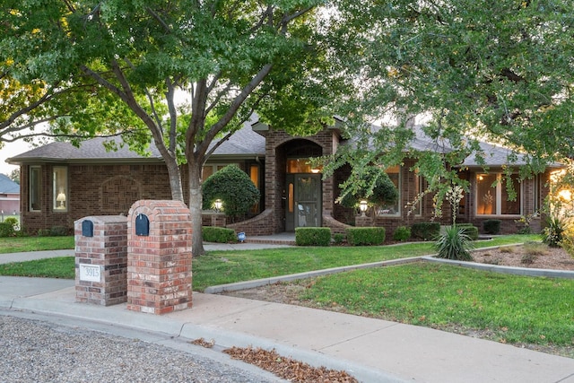 obstructed view of property featuring a front yard